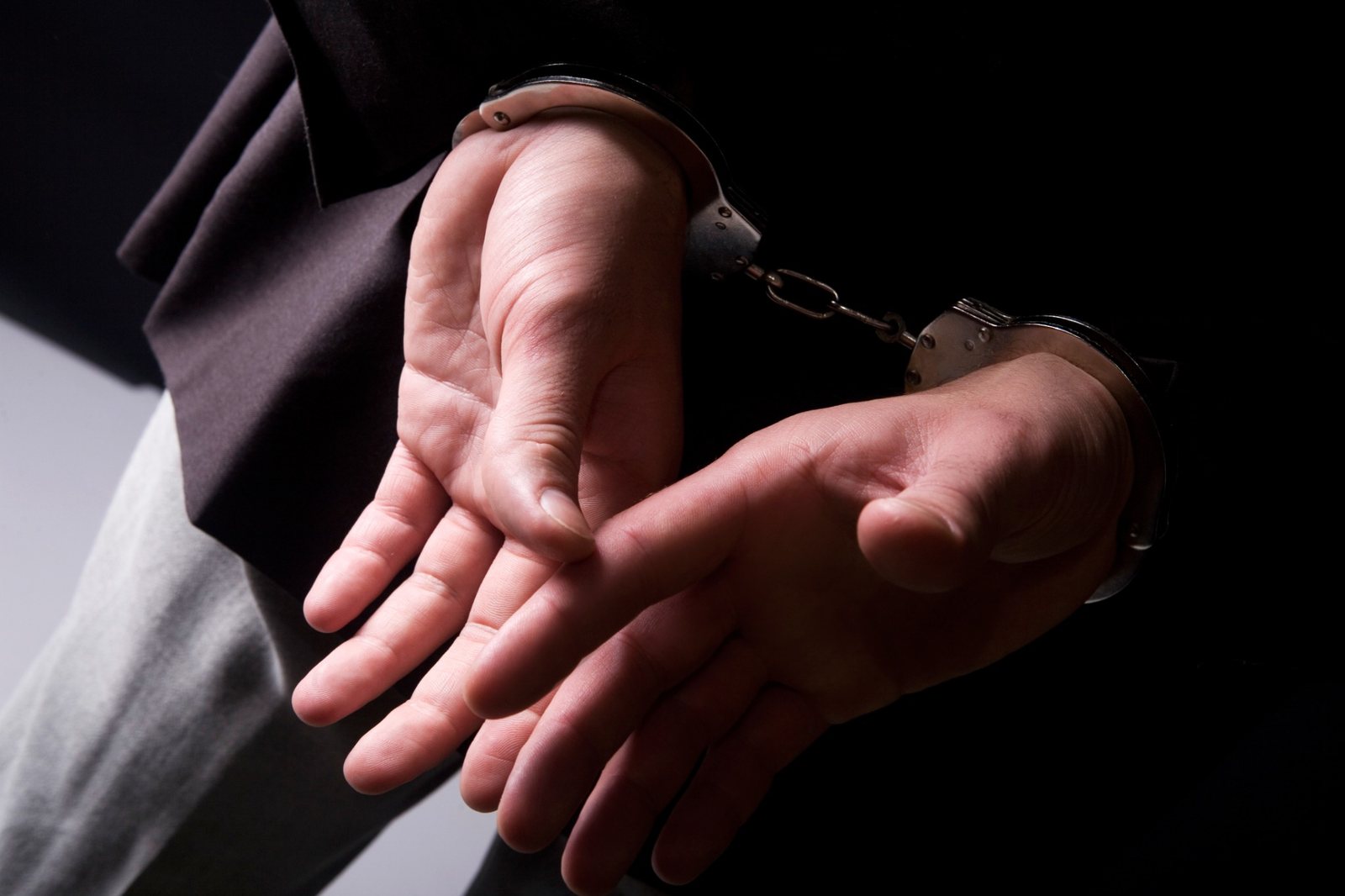 Business professional in handcuffs