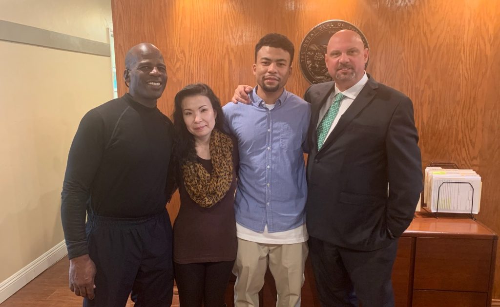 Spencer Rhines with family and attorney Mark Anthony Raimondo following his release